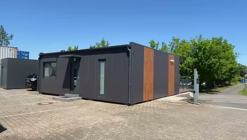 Guided tour of a completed Aftarkis Spiti modular home — exterior cladding, open-plan living area with floor-to-ceiling glazing, fitted kitchen and terrace